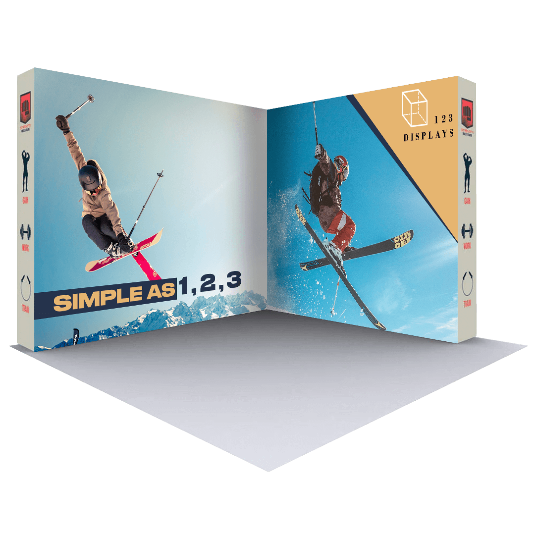 Two skiers jumping and performing aerial tricks on skis in front of a snowy mountain backdrop. The image is framed by a 3D rendering of an open cube-shaped trade show display branded with the 123displays logo and "Simple as 1,2,3" tagline. The display features the skiers' action shots on the interior panels.